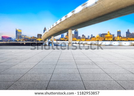 Empty square floor and city skyline with bridge in Shanghai at night