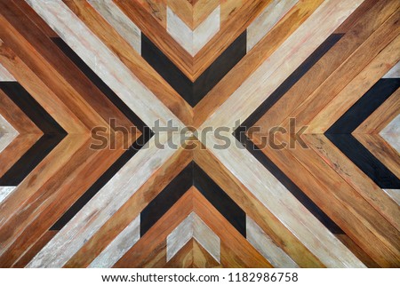 seamless yellow, black, white and dark brown color lumber in arrows or chevron pattern to the center for texture background. top view
