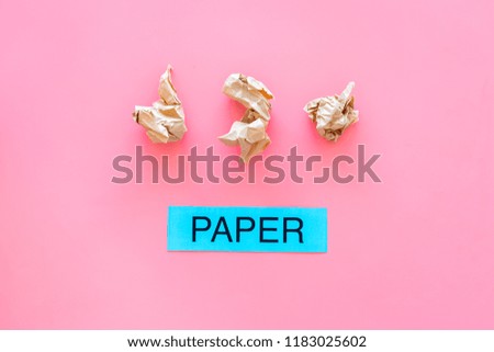 Waste suitable for recycle. Crumpled paper near printed word paper on pink background top view copy space