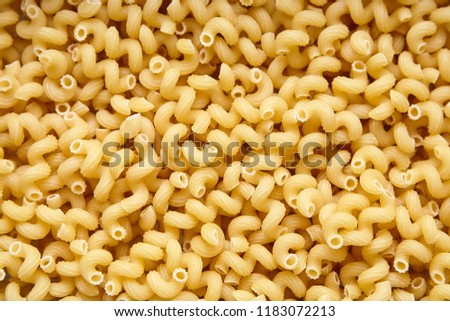 Heap of Dry Uncooked Cavatappi Italian Pasta . Food Background  Royalty-Free Stock Photo #1183072213