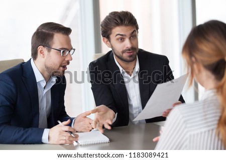 Male recruiters surprised by work achievements or experience in resume of female job applicant during interview, amazed HR managers shocked with woman candidate career. Good first impression concept Royalty-Free Stock Photo #1183089421