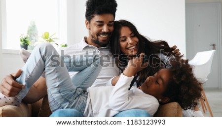 Happy family watching television at their home