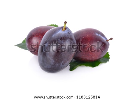 whole fresh prunes with leaf on white background