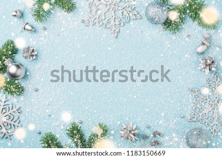 Light blue Christmas frame. Fir tree, New Year ornaments. Winter holiday snowy background, copy space, flat lay.