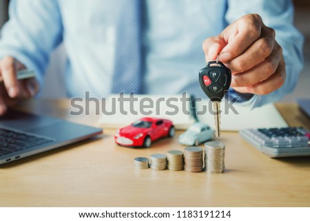 car dealer hand holding key. concept car insurance and financing