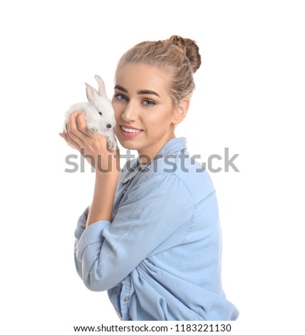 Beautiful young woman with cute rabbit on white background
