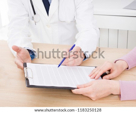 Doctor with patient in medical office sign a contract. Healthcare concept. Medical insurance.