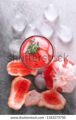 Glass of refreshing grapefruit lemonade on table, top view