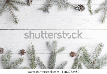 Christmas composition with frame of fir branches, Christmas decorations and pine cones. Flat lay, top view