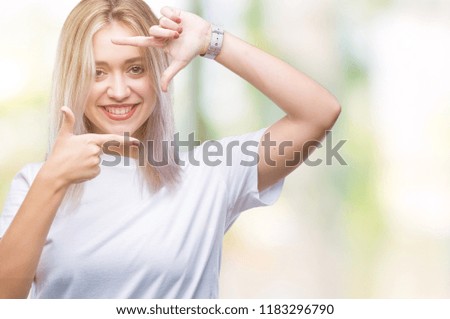Young blonde woman over isolated background smiling making frame with hands and fingers with happy face. Creativity and photography concept.