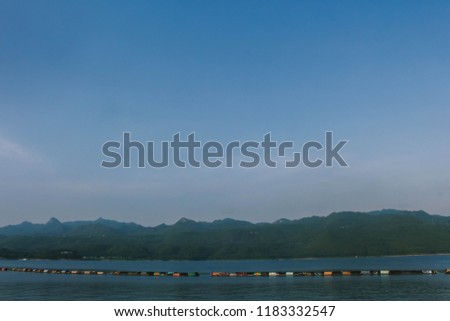 Dam, hills and cloudy blue sky
