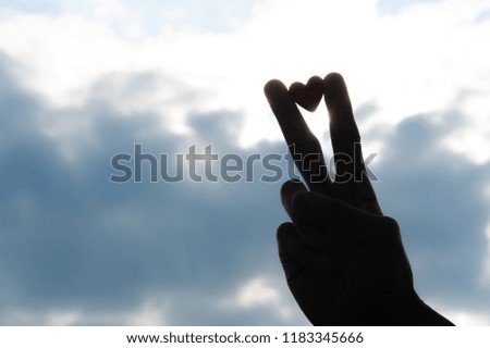 Heart mark object pinched by v sign