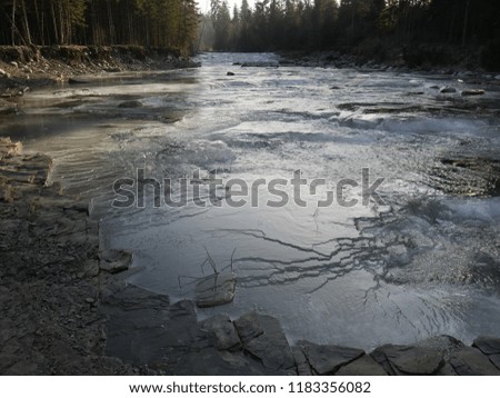 Frozen river with ice in the mountains