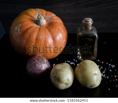 Dark, close up, picture showing the ingredients for a pumpkin soup with dark background