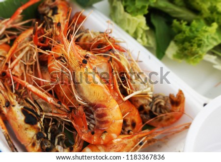   Grilled king prawn in plastic tray                             