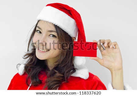 Girl in Santa holding red card. Cute funny photo closeup of christmas woman with copyspace. Isolated on white background.