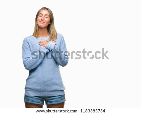Young beautiful woman wearing winter sweater over isolated background smiling with hands on chest with closed eyes and grateful gesture on face. Health concept.
