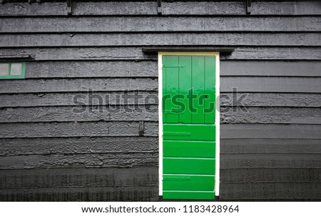 Bright green on black wooden building