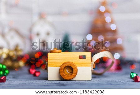 Wooden camera with defocused bokeh background. Copyspace with room for your text.