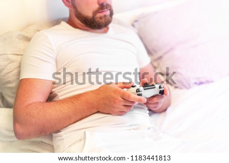 man with a beard playing a game console, copy space