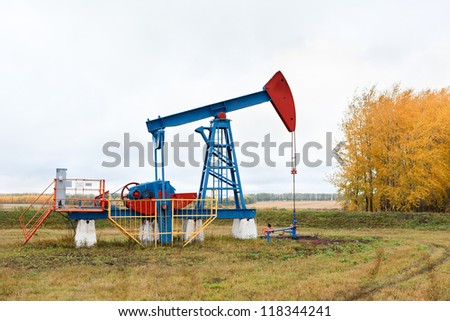 One pump jacks on a oil field. Autumn