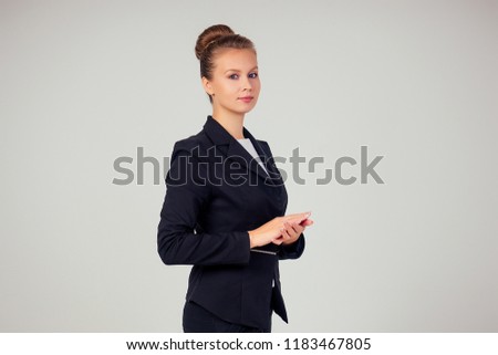 beautiful woman in a business black suit in the studio on a white background