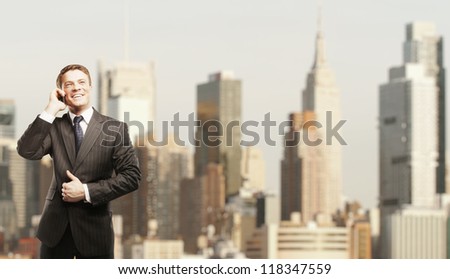 businessman with phone on city background