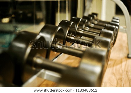 Closeup picture of dumbbell on the rack in the fitness room for working out and healthy