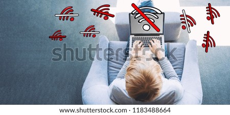 No WiFi theme with man using a laptop in a modern gray chair