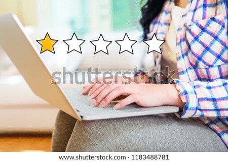 One Star Rating with young woman using a laptop computer
