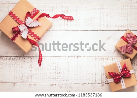 Gift boxes with ribbon on white wooden background. Top view with copy-space