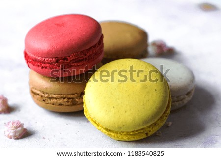 Colorful french macaroons on the blue table close up
