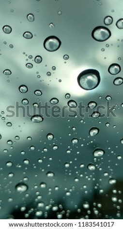 Water droplets on glass with dark and light background 