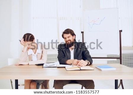 man and woman are sitting at the table                            