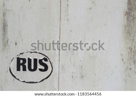 Inscription RUS on old metal wall. Metal texture with copy space for design or text. Industrial background