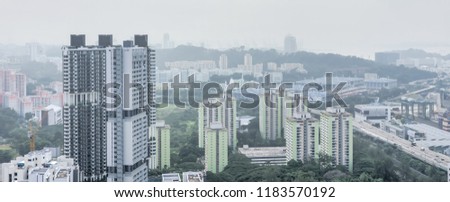 Panorama typical aerial view of residential building skyscraper HDB at the South of Singapore city center. Modern cityscape surrounded by green trees under haze sunset