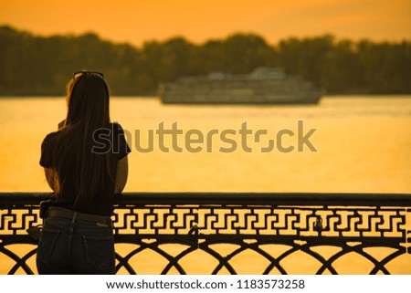 the girl on the waterfront at sunset
