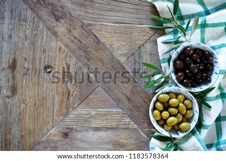 Mediterranean food background. Wooden table with checkered tablecloth and olives