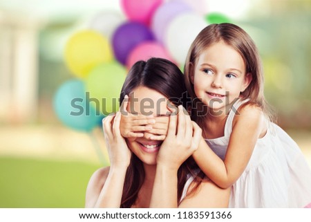 Portrait of happy mother and daughter holding