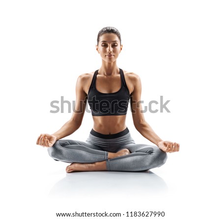 Sporty young woman doing yoga practice isolated on white background. Concept of healthy life and natural balance between body and mental development. Full length