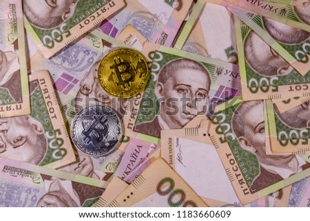Bitcoin coins on ukrainian five hundred hryvnas banknotes