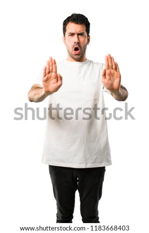 Young man with white shirt making stop gesture with her hand for disappointed with an opinion on isolated white background