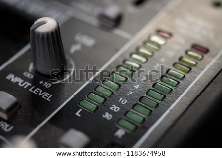 Pro Audio Master signal output meters and input control on a professional sound mixing console/ desk