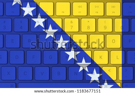 Bosnian flag and computer keyboard in the background. Bosnia and Herzegovina flag
