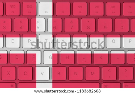 Danish flag and computer keyboard in the background. Denmark flag