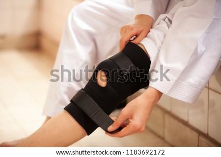 leg with one knee in a protective knee brace Royalty-Free Stock Photo #1183692172