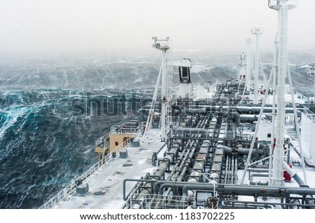 Big gas carrier sailing through an stormy arctic sea. Royalty-Free Stock Photo #1183702225