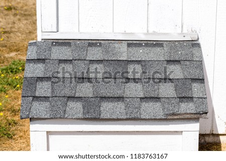 Composite roof shingles on a shed 