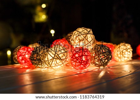 christmas lights on dark wooden background with reflections.
Christmas and New Year holidays background. 