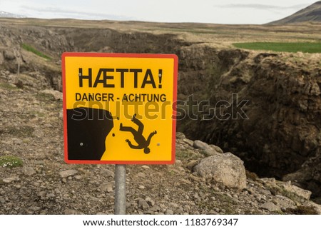 Danger sign in Icelandic (and English and German) - warning tourists of steep cliffs
